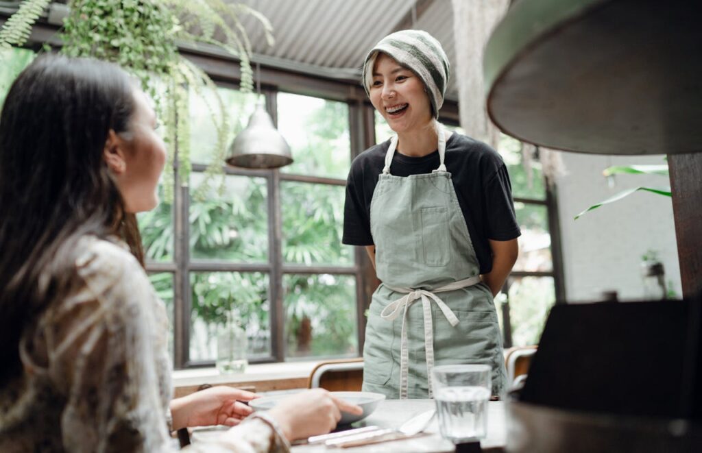 Restaurant Staff Reaching Out To Customer Delivery app strategy